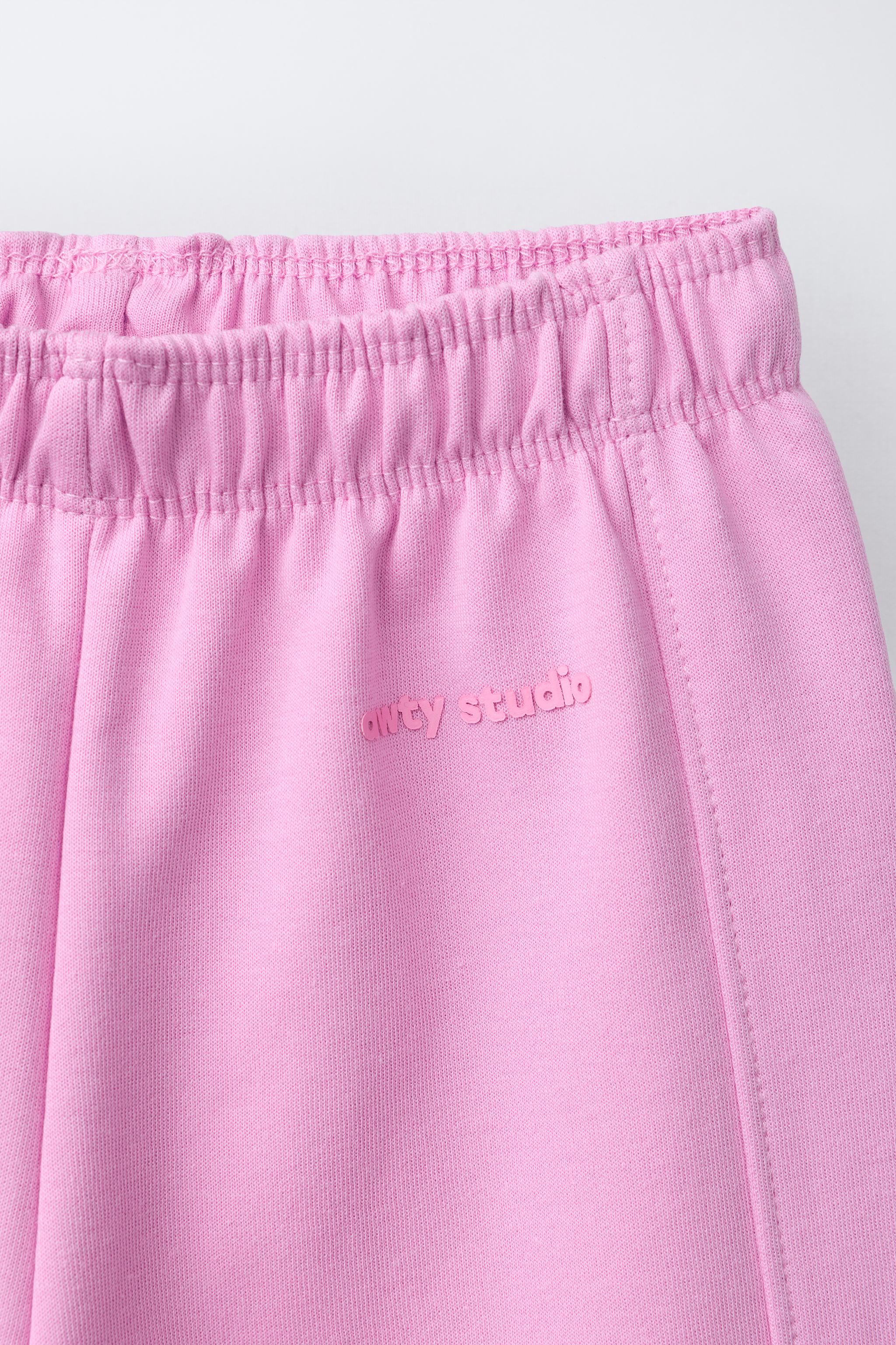 WIDE LEG INTERLOCK RAISED TEXT PANTS